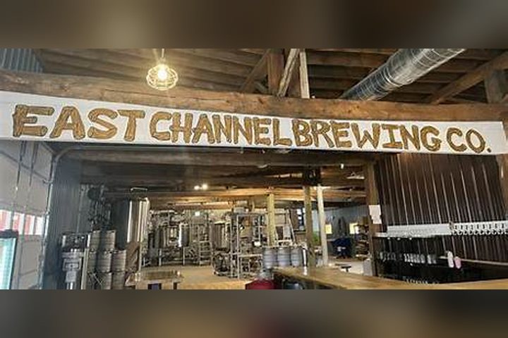 Inside East Channel Brewing Co., with its carved sign over the brewhouse