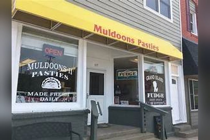 Muldoons Pasties storefront with its yellow awning in Munising