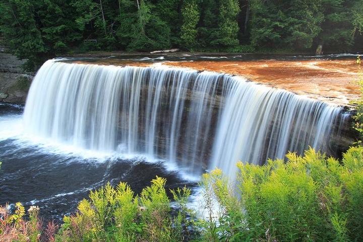 The wide, amber Upper Tahquamenon Falls
