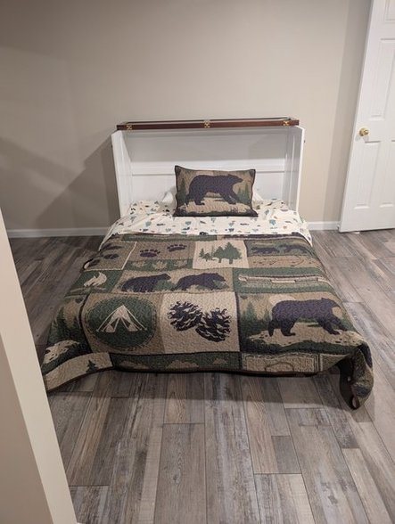 Full Murphy bed folded down in the lower-level bunk room